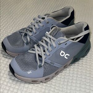 On Running Gray and Blue Athletic Shoes with Modern Design